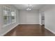 Formal dining room with beautiful hardwood floors, a modern chandelier, and large windows at 4252 Rockdell Hall St, Raleigh, NC 27616