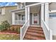 Close-up of the inviting front porch with brick steps and elegant white columns at 4252 Rockdell Hall St, Raleigh, NC 27616