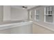Bright hallway with large windows and carpeted floors. A view from the top of a staircase at 4252 Rockdell Hall St, Raleigh, NC 27616