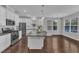 Spacious kitchen with island, stainless appliances, and hardwood floors at 4252 Rockdell Hall St, Raleigh, NC 27616