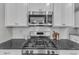 Modern kitchen with stainless steel appliances and granite countertops at 4252 Rockdell Hall St, Raleigh, NC 27616