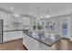 Bright kitchen featuring granite countertops, white cabinets, and stainless steel appliances at 4252 Rockdell Hall St, Raleigh, NC 27616