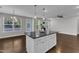 Kitchen island with granite countertops, white cabinets and stainless appliances at 4252 Rockdell Hall St, Raleigh, NC 27616