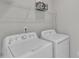 Utility laundry room area including a full-sized washer and dryer at 4252 Rockdell Hall St, Raleigh, NC 27616