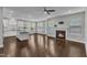 Open floor plan combining the kitchen and living room with dark hardwood floors and fireplace at 4252 Rockdell Hall St, Raleigh, NC 27616