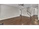 Spacious living room featuring dark hardwood floors and a ceiling fan at 4252 Rockdell Hall St, Raleigh, NC 27616
