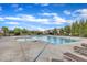 Community pool with sun loungers surrounded by lush greenery, perfect for relaxation on sunny days at 4252 Rockdell Hall St, Raleigh, NC 27616