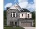 Charming two-story home showcasing a stone facade, arched windows, and a two-car garage at 4311 Emeline Way # 13, Fuquay Varina, NC 27526