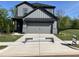 New two-story home with gray siding, a two-car garage and a concrete driveway at 4404 Darius Ct # 41, Fuquay Varina, NC 27526