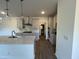 Well-equipped kitchen featuring a range hood, subway tile backsplash, and an island sink at 4404 Darius Ct # 41, Fuquay Varina, NC 27526