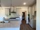 Open kitchen with gray cabinets, subway tile backsplash, quartz countertops, and stainless appliances at 4404 Darius Ct # 41, Fuquay Varina, NC 27526