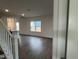 Inviting living space with abundant natural light, hardwood floors, and a view of the open-concept layout at 4404 Darius Ct # 41, Fuquay Varina, NC 27526