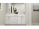 Bright bathroom featuring a double vanity, stylish decor, and white cabinets, providing a modern and clean aesthetic at 472 Carolina Springs Blvd, Apex, NC 27539