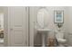 A well-lit half bath with a pedestal sink and decorative art at 472 Carolina Springs Blvd, Apex, NC 27539