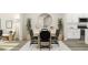 Open-concept design featuring a modern dining table with black chairs, a large mirror, and a kitchen in the background at 472 Carolina Springs Blvd, Apex, NC 27539