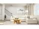 Cozy living room with a sectional sofa, stylish coffee table, and staircase providing comfort and modern design at 472 Carolina Springs Blvd, Apex, NC 27539