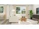 Bright living room with sectional sofa, natural wood coffee table, large windows, and stylish decor creating a welcoming space at 472 Carolina Springs Blvd, Apex, NC 27539