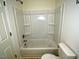 Bathroom featuring a shower over the tub and a toilet with a white seat at 48 S Grace Way, Henderson, NC 27537