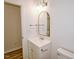 Bathroom with a white vanity, gold fixtures, and a framed mirror at 48 S Grace Way, Henderson, NC 27537