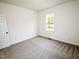 Bedroom with fresh paint, new carpet, and a sunny window at 48 S Grace Way, Henderson, NC 27537