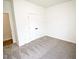 Bedroom with new carpet, fresh paint, and a double door closet at 48 S Grace Way, Henderson, NC 27537
