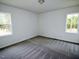 Sun-filled bedroom with gray carpet and view of the surrounding yard at 48 S Grace Way, Henderson, NC 27537