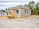Inviting single-story house with a covered front porch, complemented by neat landscaping and exterior lighting at 48 S Grace Way, Henderson, NC 27537