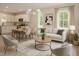 Bright, open-concept living area flowing into kitchen and dining, styled with modern furniture and natural light at 48 S Grace Way, Henderson, NC 27537