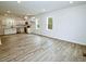Expansive living space featuring an open-concept layout with light wood flooring and abundant natural light at 48 S Grace Way, Henderson, NC 27537