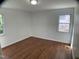 A bright bedroom is illuminated by two windows and features hardwood flooring at 509 Coleman St, Raleigh, NC 27610