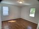 Bright bedroom with hardwood floors illuminated by the sun at 509 Coleman St, Raleigh, NC 27610