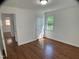 Bright bedroom with hardwood floors, a window, and an access door at 509 Coleman St, Raleigh, NC 27610