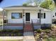 Charming home exterior with a porch, garden and black trimmed windows at 509 Coleman St, Raleigh, NC 27610