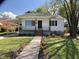 Charming home with a landscaped front yard and a walkway lined with colorful flowers at 509 Coleman St, Raleigh, NC 27610