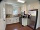 Modern kitchen boasts stainless steel appliances, white cabinetry, and hardwood floors at 509 Coleman St, Raleigh, NC 27610