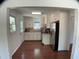 Well-lit kitchen featuring stainless steel appliances, white cabinets, and hardwood floors at 509 Coleman St, Raleigh, NC 27610