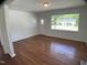 Inviting living room with hardwood floors and a bright window showcasing neighborhood views at 509 Coleman St, Raleigh, NC 27610