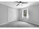 Neutral bedroom features a ceiling fan, plush carpet, and a window with natural light at 5301 Night Heron Dr, Wake Forest, NC 27587