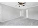 Carpeted bedroom with ceiling fan, white trim, and access to other rooms at 5301 Night Heron Dr, Wake Forest, NC 27587