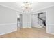 Bright dining room featuring modern lighting, neutral walls, and hardwood flooring, and stairs at 5301 Night Heron Dr, Wake Forest, NC 27587
