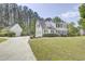 Stately white two-story home with black shutters, a detached garage and well-manicured lawn at 5301 Night Heron Dr, Wake Forest, NC 27587