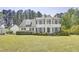 Beautiful two-story home with black shutters, landscaped front yard, and a charming gable-roof garage at 5301 Night Heron Dr, Wake Forest, NC 27587