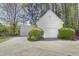 Detached white garage with lush landscaping at 5301 Night Heron Dr, Wake Forest, NC 27587
