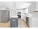 Modern kitchen with stainless steel appliances, a center island, and sleek white cabinetry at 5301 Night Heron Dr, Wake Forest, NC 27587