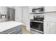 Close-up of a modern kitchen with stainless steel appliances, white cabinets, and sleek countertops at 5301 Night Heron Dr, Wake Forest, NC 27587