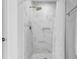 Bright shower with marble tile, gold shower head, and recessed shelf at 5301 Night Heron Dr, Wake Forest, NC 27587