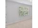 Bright bedroom featuring neutral walls and carpet, with window and natural light at 5318 Crescentview Pkwy, Raleigh, NC 27606