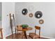 Cozy dining area with hardwood floors, decorative wall art, and ladder with throw blanket at 5318 Crescentview Pkwy, Raleigh, NC 27606