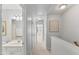 Bright hallway featuring neutral decor, with view into bathroom with vanity and mirror at 5318 Crescentview Pkwy, Raleigh, NC 27606