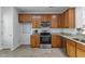 Well-lit kitchen featuring stainless steel appliances and wood cabinets, great for cooking at 5318 Crescentview Pkwy, Raleigh, NC 27606